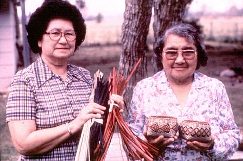 Chitimacha Indians Ernestine Walls and Lydia Darden of Charenton display the materials for their rivercane baskets. The Chitimacha are well known for their rivercane baskets which are either single weave as displayed here or double weave which has two layers of baskets: a basket within a basket. The Choctaw and Koasati Indians also use rivercane to make baskets, but each tribe has different patterns and styles involving the width of the individual splints.